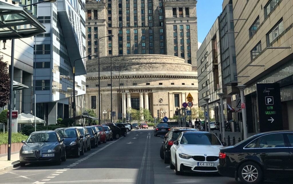 The car is parked next to the office building