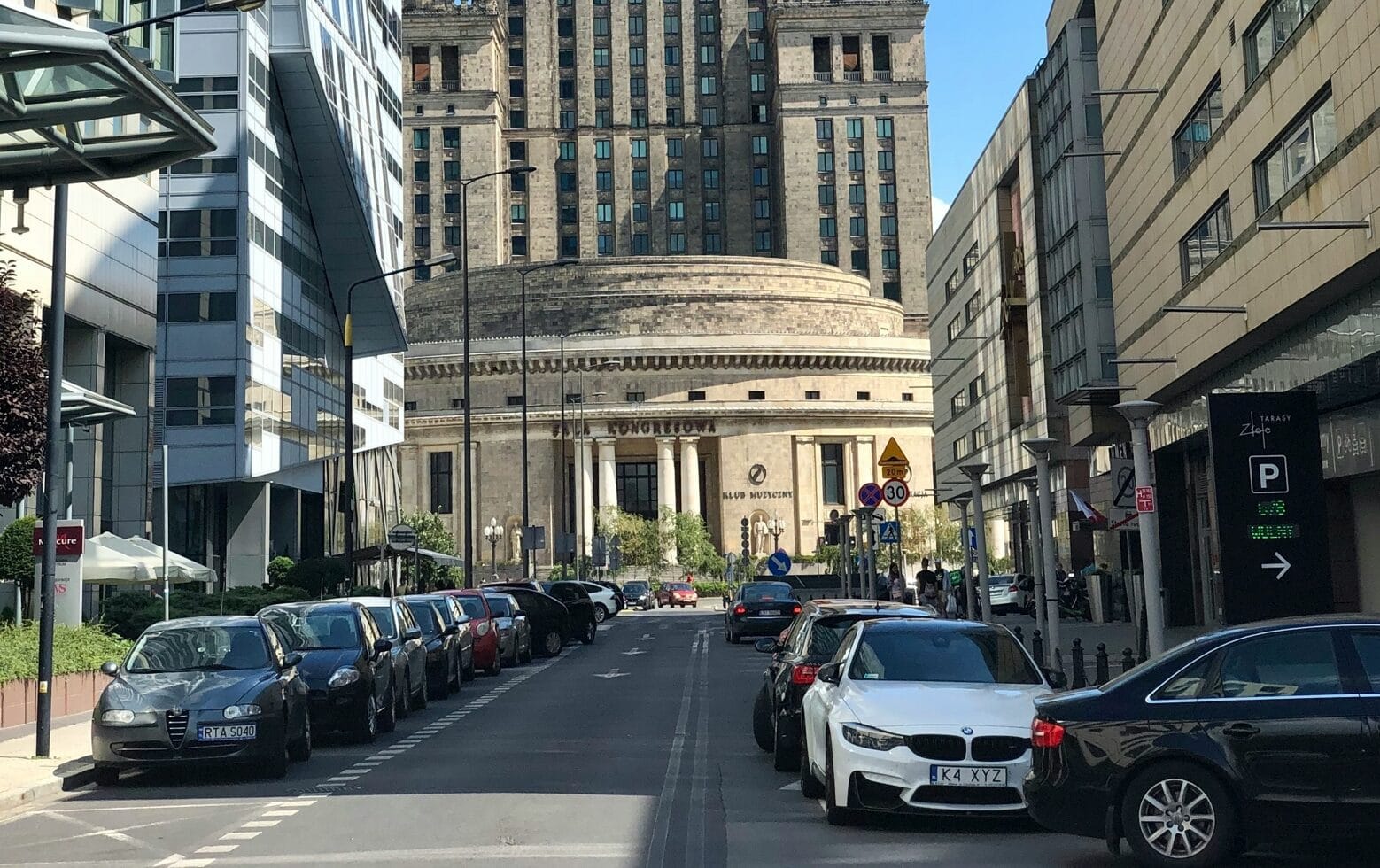 The car is parked next to the office building